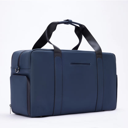 Men's gym duffle bag in navy blue with black straps, sleek design, and side pocket for organized athletic storage.

Essex Blue